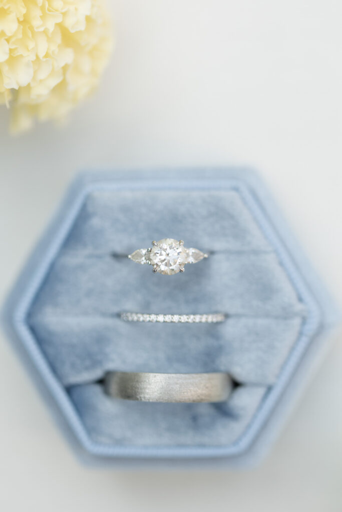 Close up shot of engagement ring and wedding bands. 