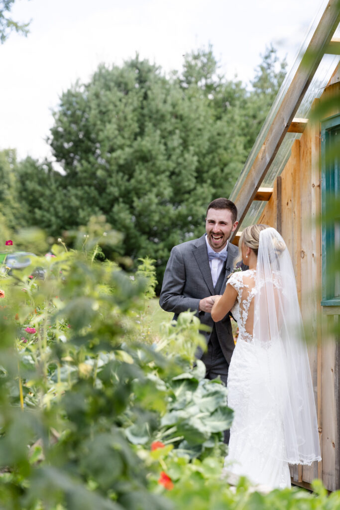 Groom happily laughs off into the distance after he sees his bride for the first time. 